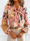 Printed bow-tie neck long-sleeve blouse with pink, blush, and dark check pattern