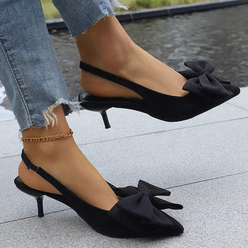 Black point-toe kitten heels with bow detail and slim ankle strap
