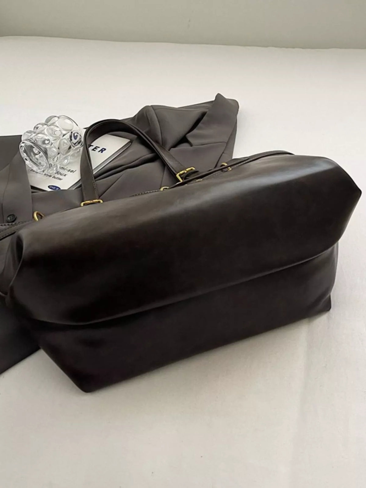Large vegan leather tote bag, black, open top with inside contents visible