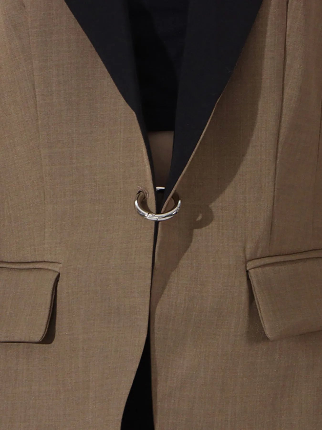 Khaki green long-sleeve blazer with black contrast lapel and metal ring front detail