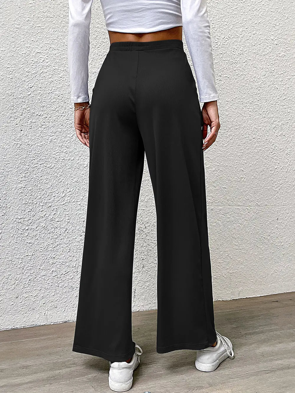 High-waist straight black pants, full back view, wide leg fit