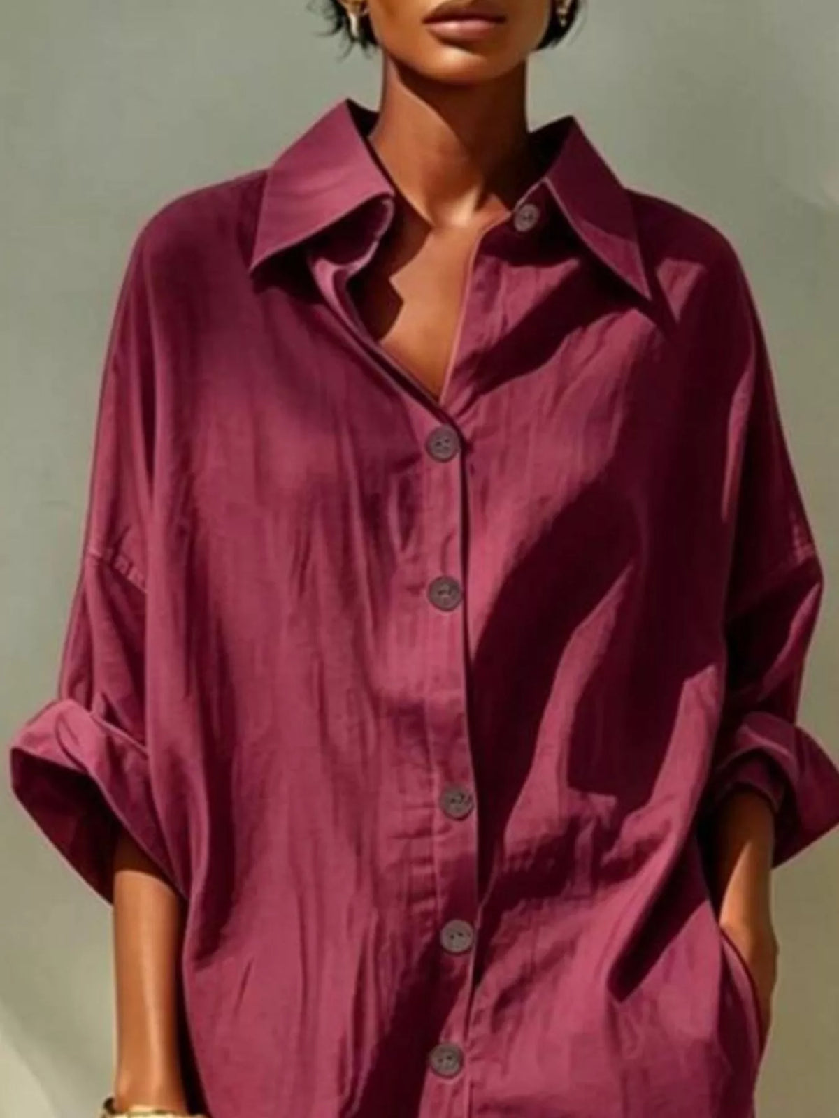 Burgundy button-front shirt dress with pointed collar, visible buttons, loose long sleeves