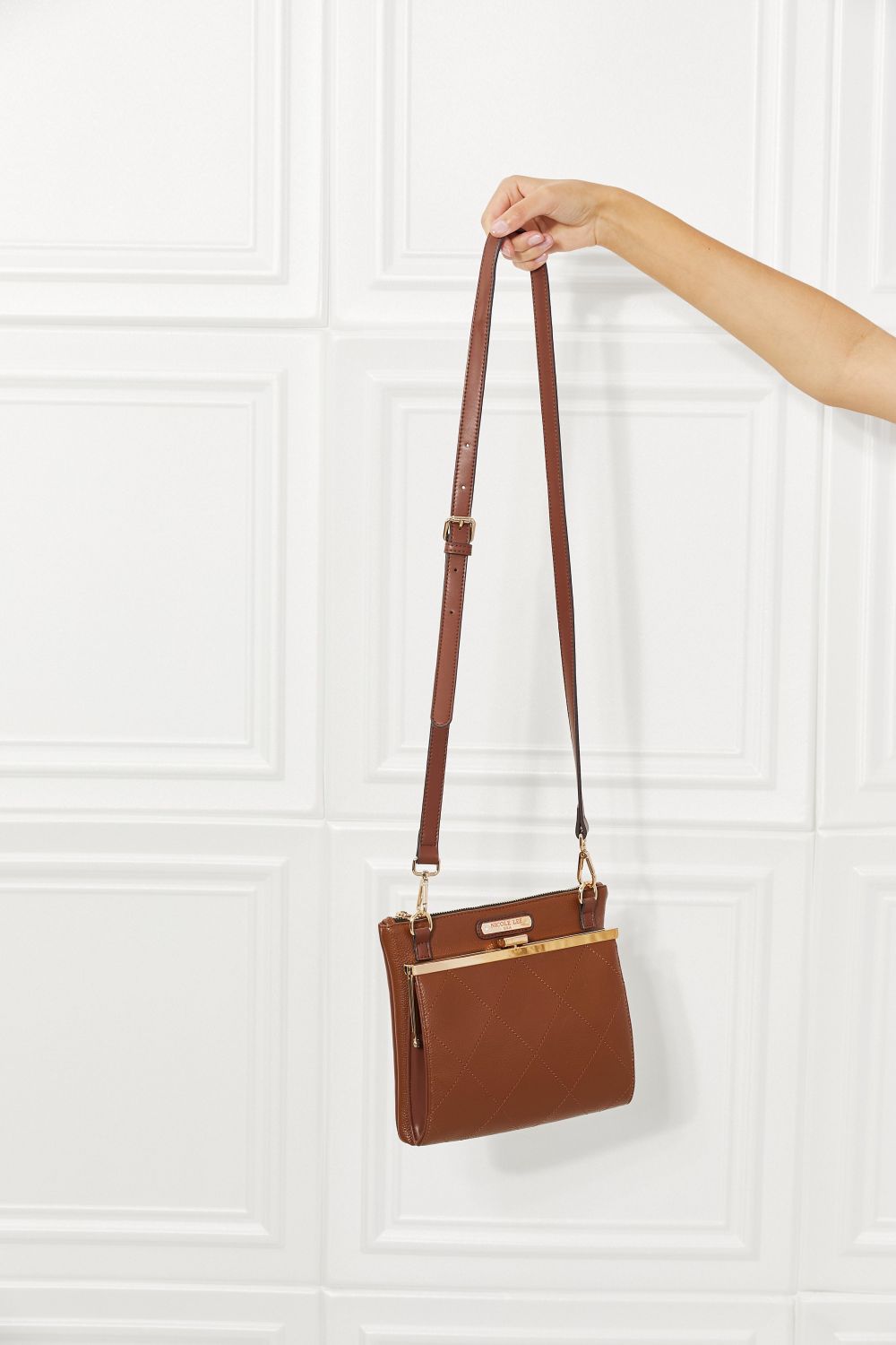 Chestnut brown mini handbag with shoulder straps and a front gold-tone clasp