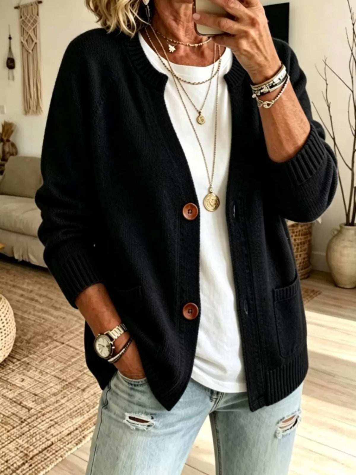 Black button-up cardigan with raglan sleeves, ribbed cuffs, and patch pockets