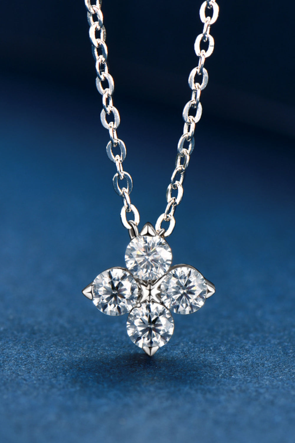Silver-tone four-leaf clover pendant necklace with four round sparkling stones on a chain