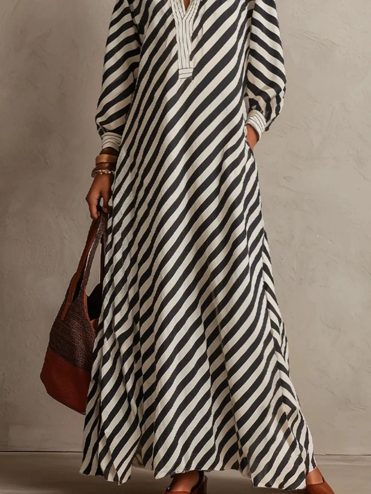 Black-and-white striped maxi dress with long sleeves and V-neck placket