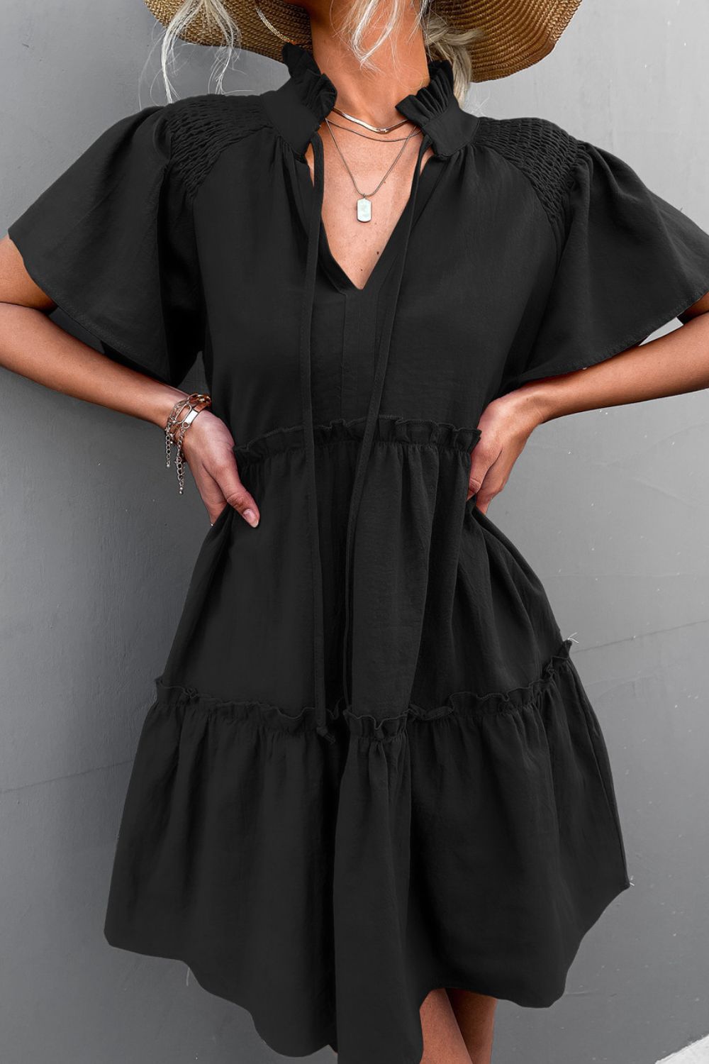Black smocked tie-neck tiered frill dress with gathered waist and puff sleeves