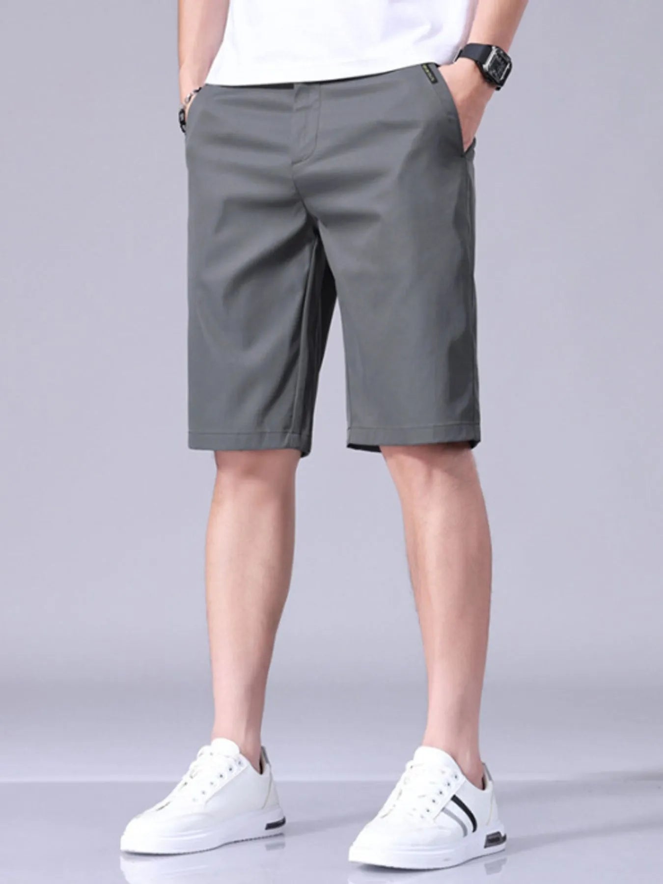Light gray men's casual shorts with pockets, belt loops, and button closure