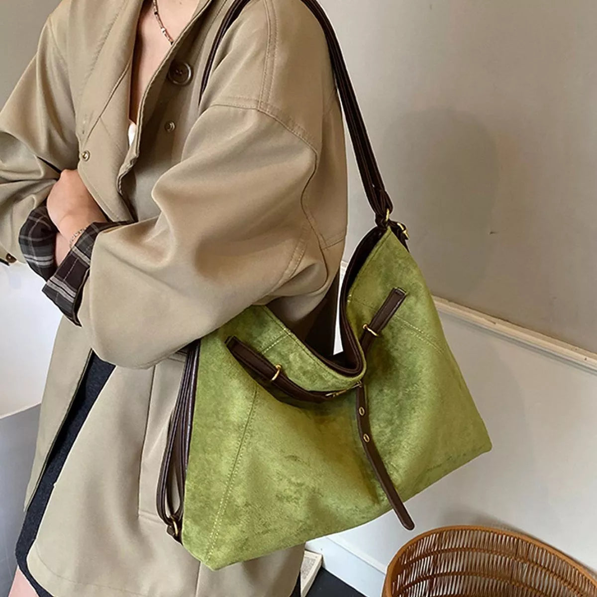 Medium green suede shoulder bag with brown contrast straps and metal buckles