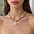 Gold beaded necklace with white starfish pendant and pearl-look beads