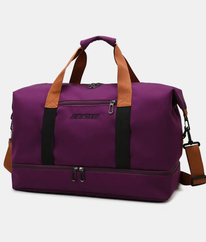 Plum purple oversize travel duffle bag with tan handles and front zipper