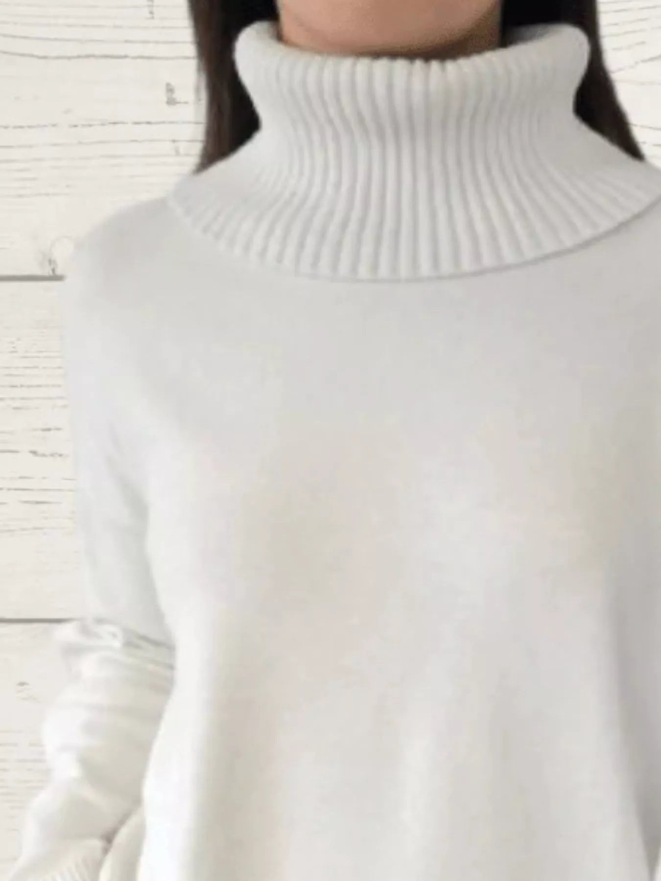 White turtleneck sweater with ribbed knit collar and long sleeves