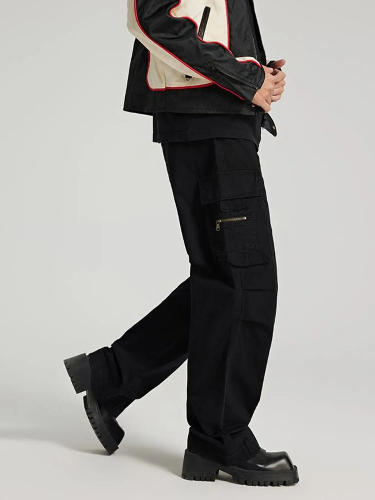 Black cargo jeans with stacked utility pockets and wide straight-leg silhouette.