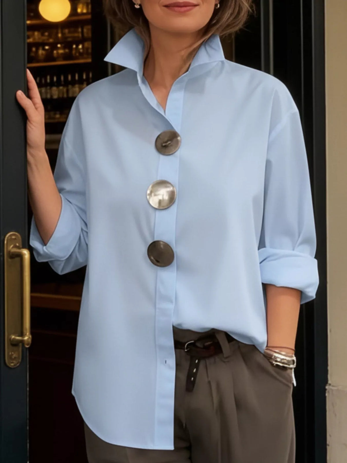 Light blue oversized long-sleeve button shirt with metallic round buttons and point collar