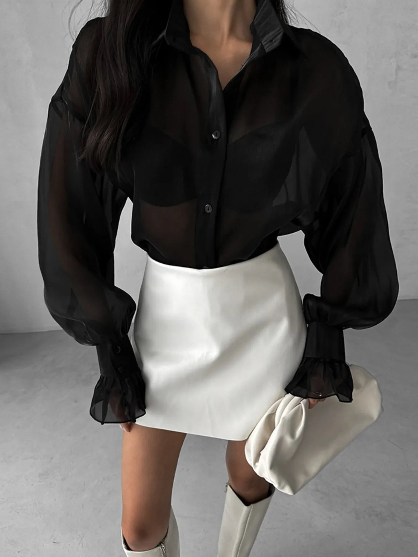 Sheer black button-up shirt with gathered flounce sleeves and visible button front