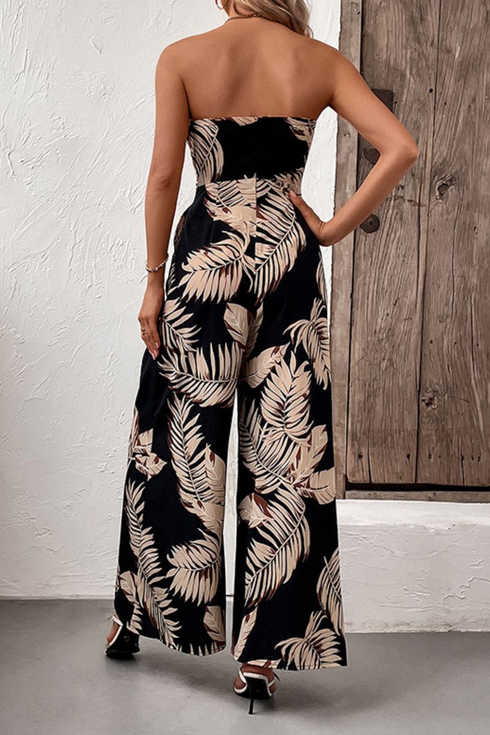 Perfee strapless wide-leg jumpsuit, back view, black with beige leaf print, tied waist