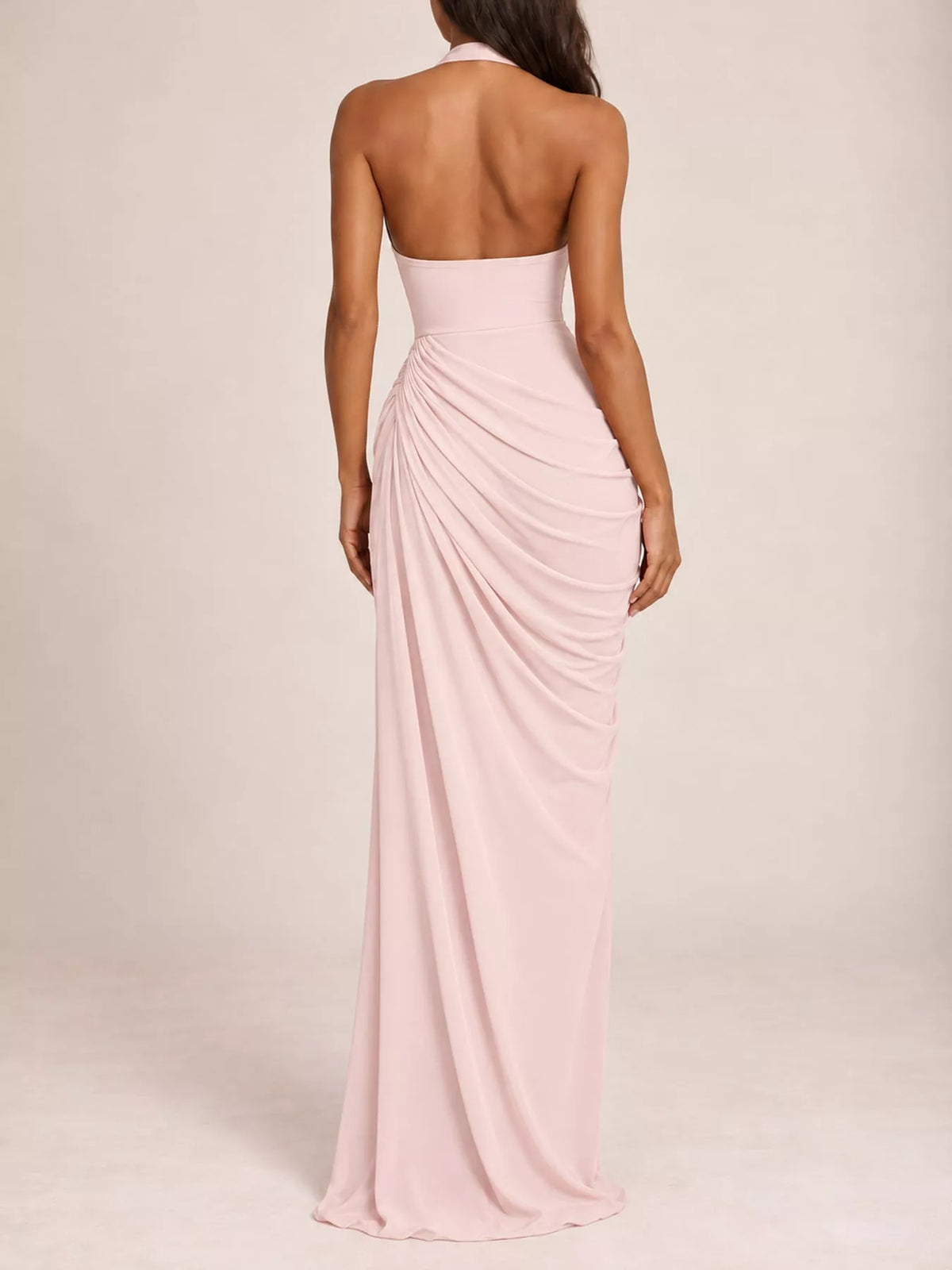 Back view of pink halter neck maxi dress with ruched drape and high slit