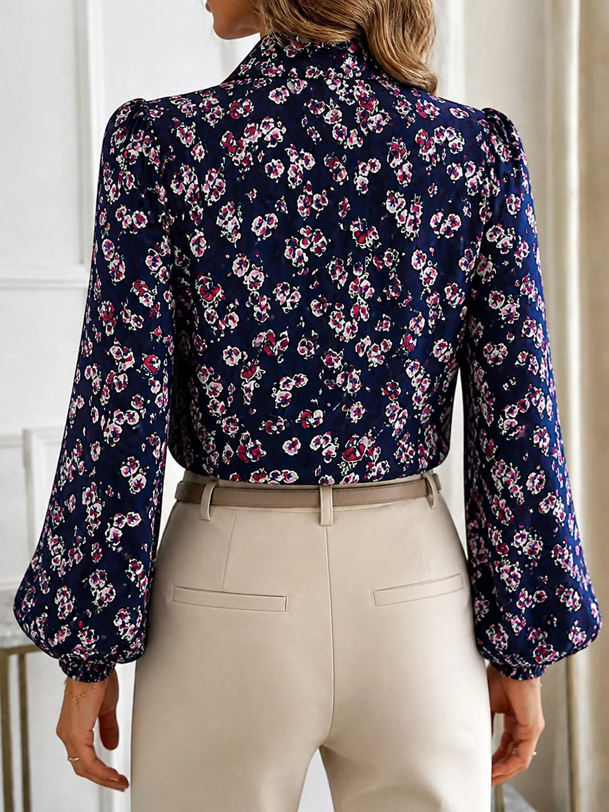 Navy printed long-sleeve blouse with high collar and tie neck detail