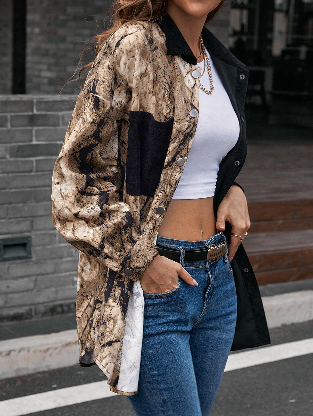 Collared contrast shirt with button placket, black sleeves and beige patterned body panels