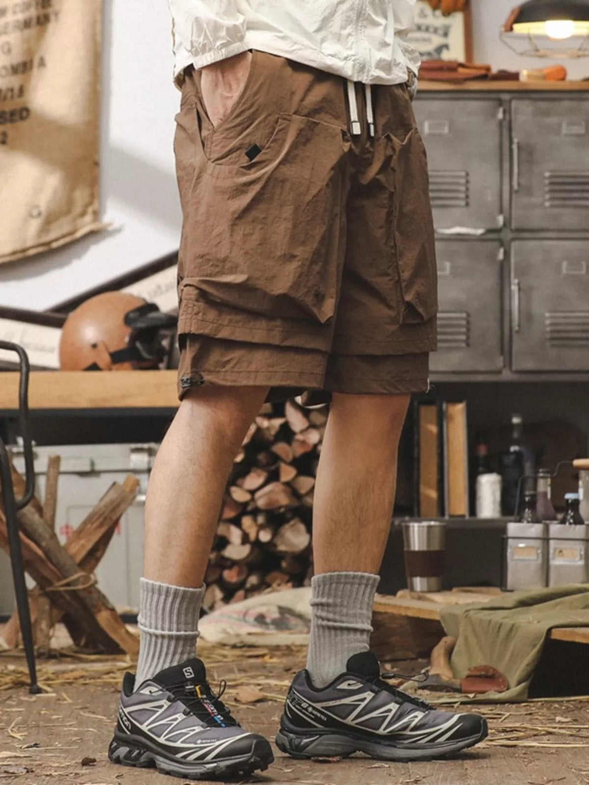 Brown men's cargo shorts, side view, drawstring waist and layered utility pockets