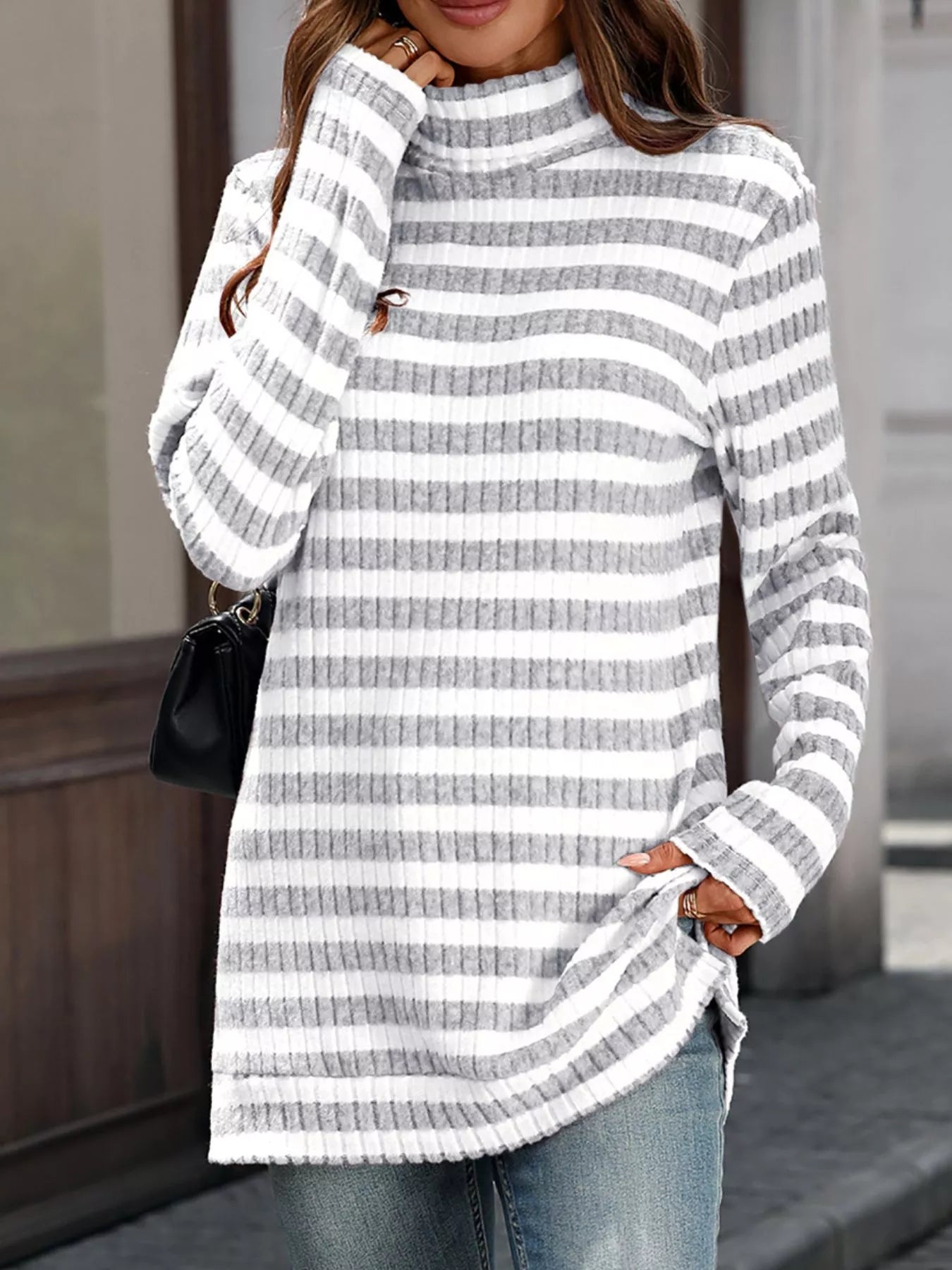 White and gray striped knit turtleneck long-sleeve top with ribbed collar and cuffs.