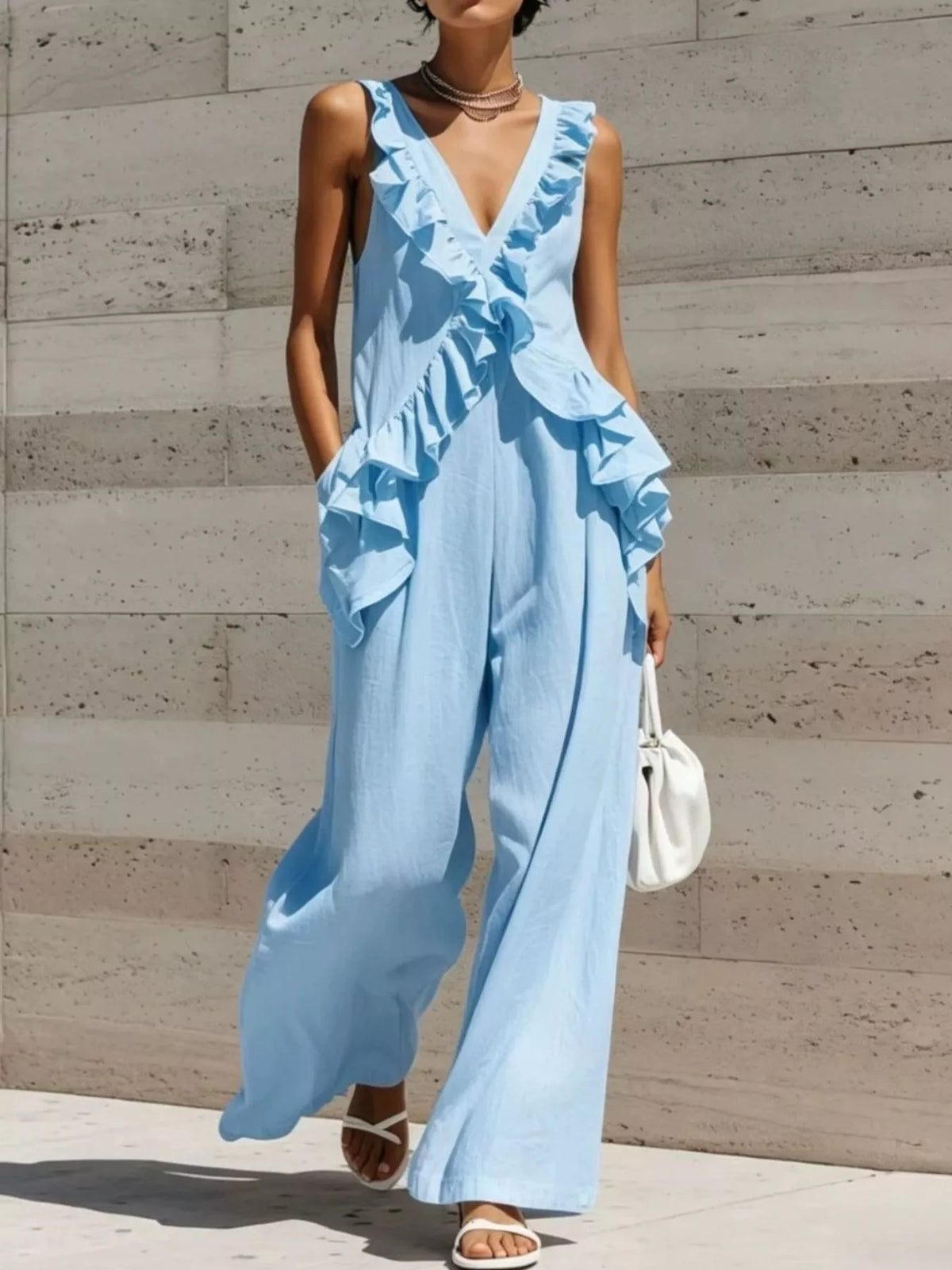 Sky blue ruffled V-neck sleeveless jumpsuit with layered ruffle detailing and wide legs