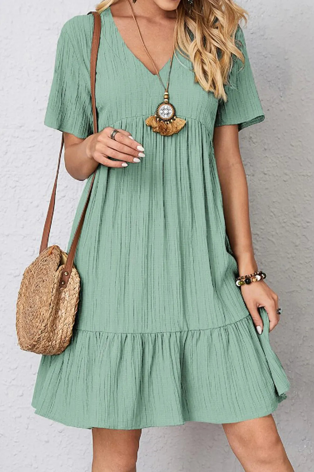 Green V-neck short-sleeve dress with gathered waist and tiered ruffle skirt