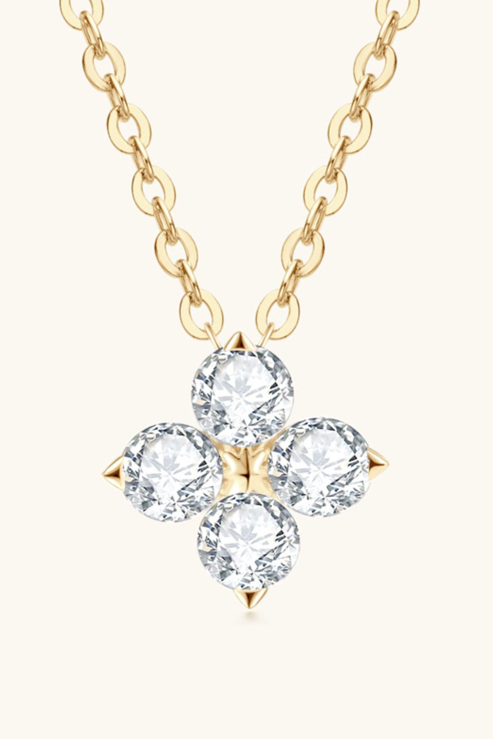 Gold-tone four-leaf clover pendant necklace with round diamond-like stones and chain links