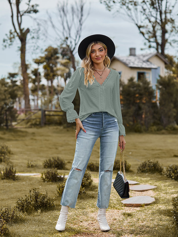 V-neck flounce-sleeve blouse in sage green, front view with ruffled neckline