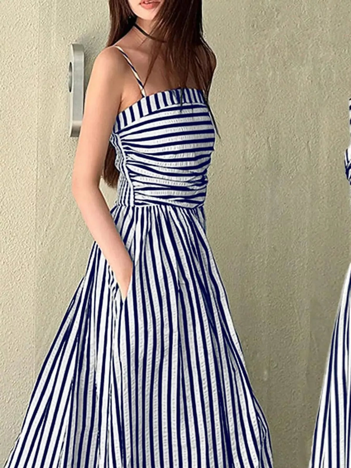 Ruched sleeveless maxi dress with blue-and-white vertical stripes, sleeveless bodice