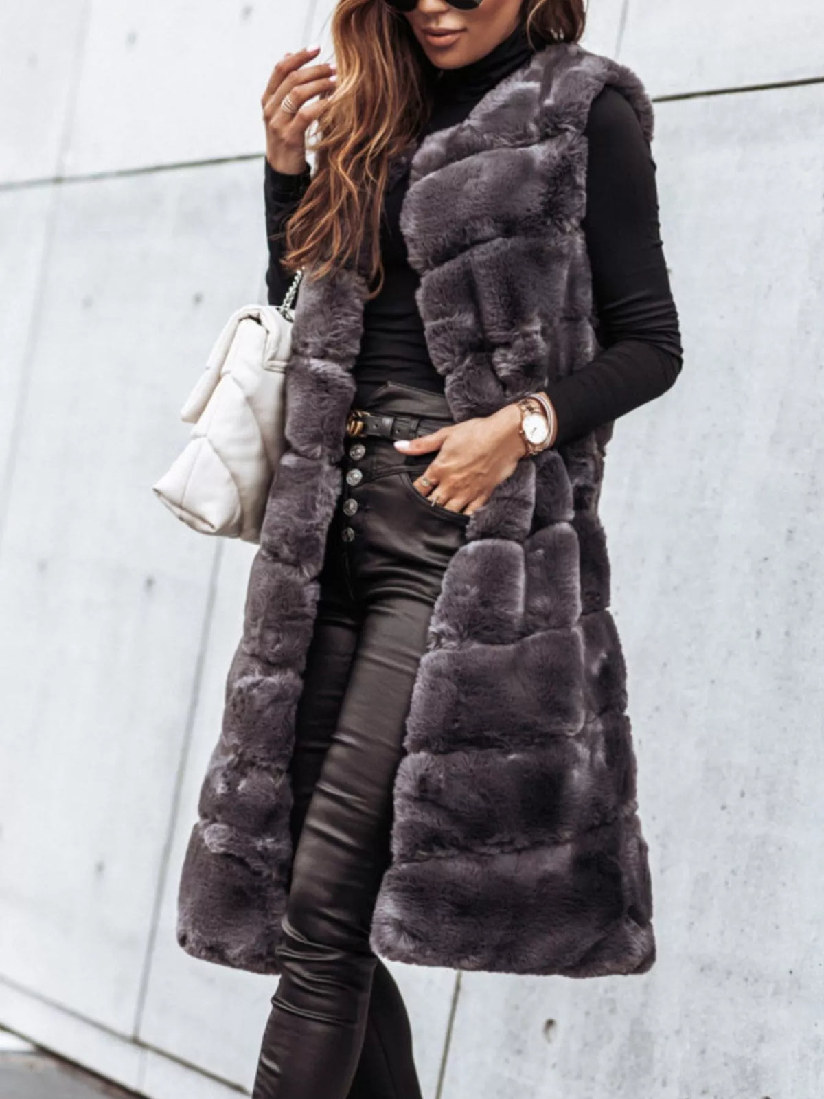 Women’s gray faux fur longline vest coat with sleeveless design and padded panel texture