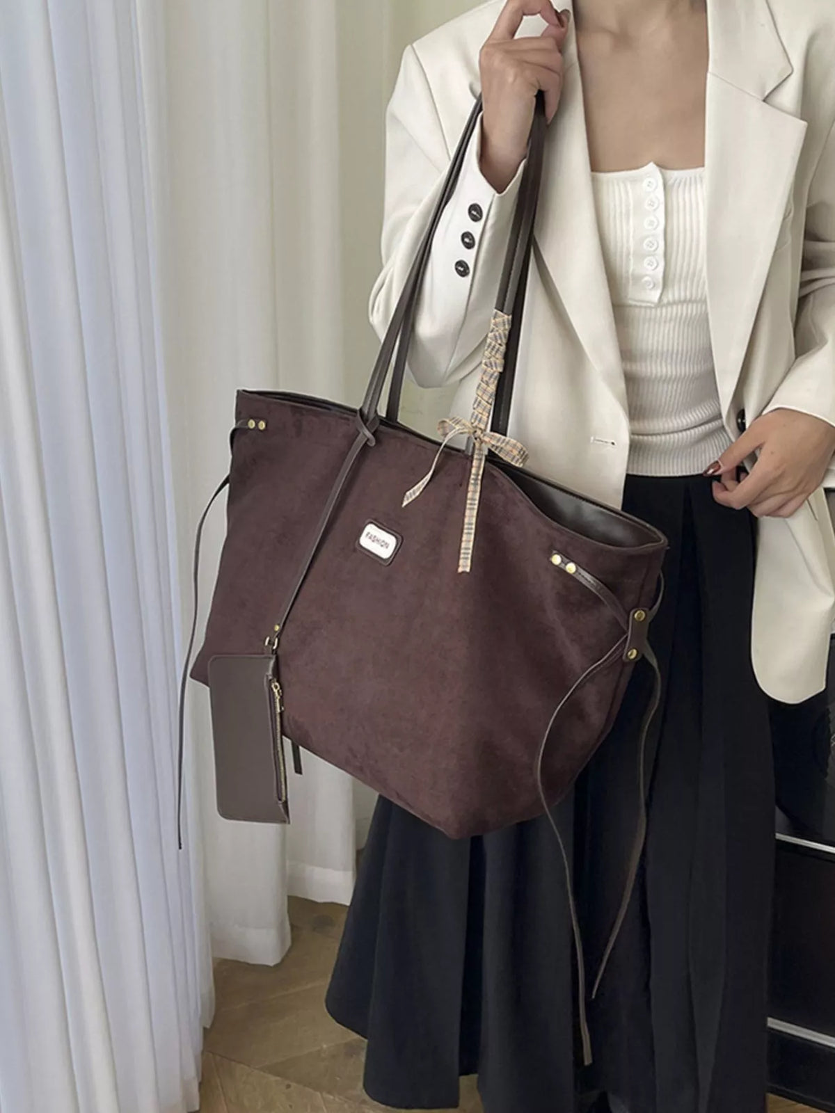Chocolate suede large tote with zip pouch, long crossbody strap, and tassel tie detail