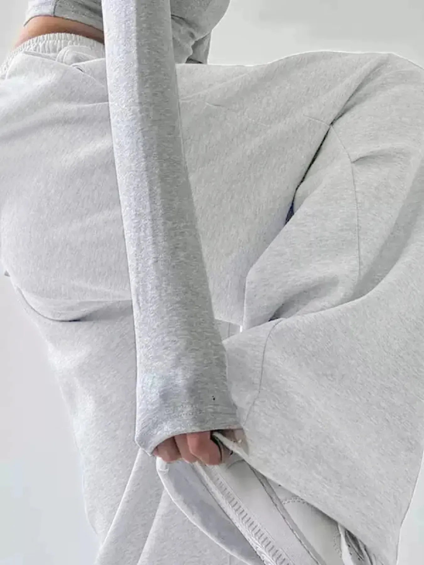 White wide-leg drawstring pants close-up of elastic waistband and side seam