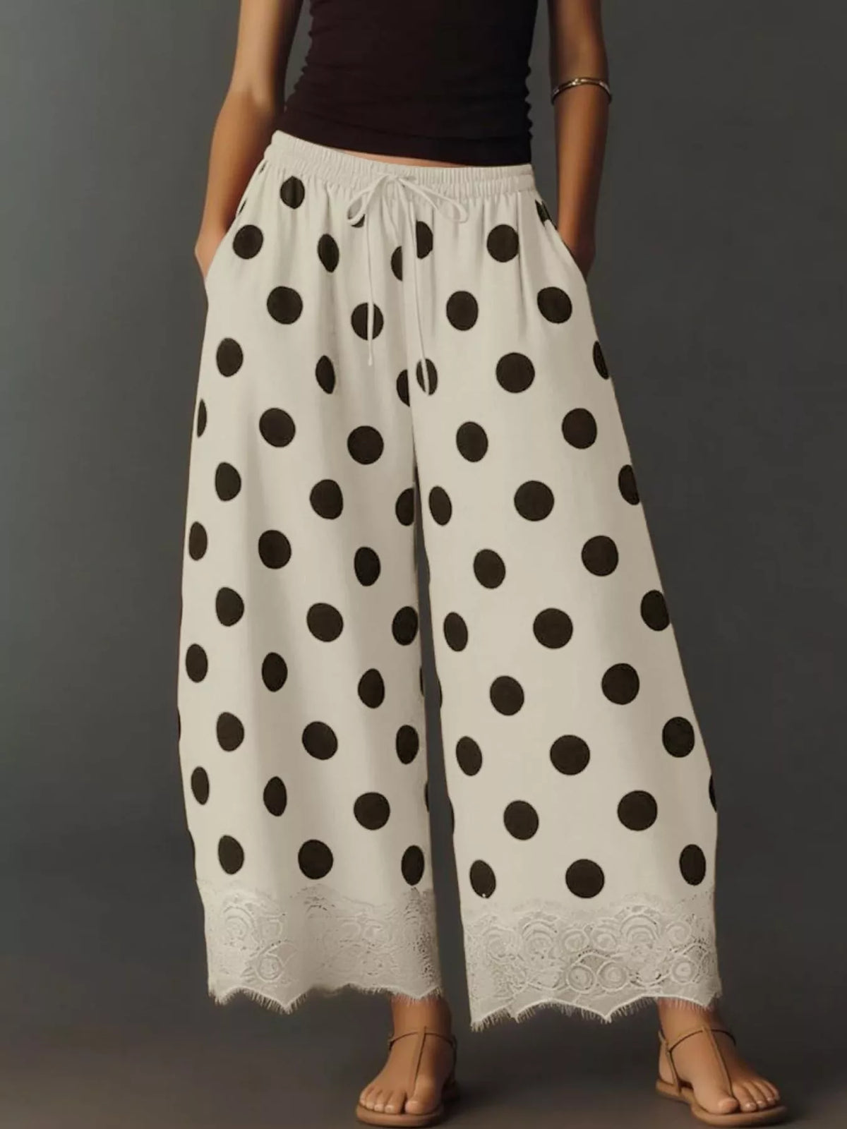 Drawstring wide-leg lace pants in white with black polka dots and lace-trim hem
