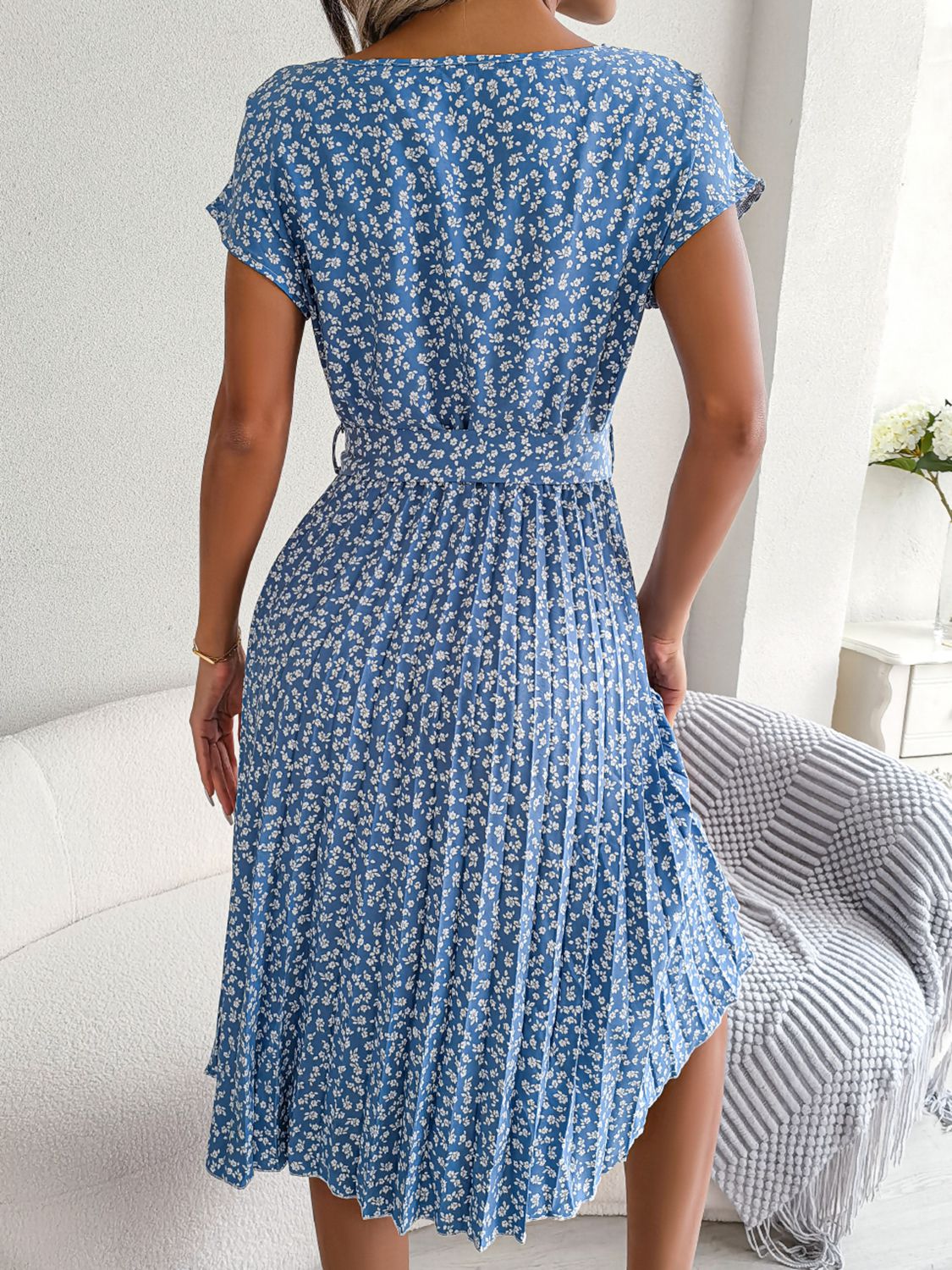 Ditsy floral pleated belted dress in sky blue, back view with pleated skirt
