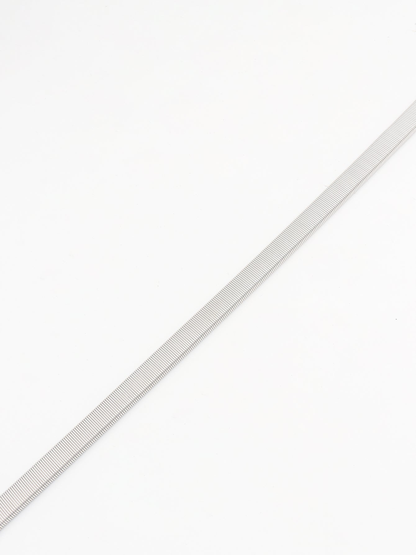Silver ribbed belt strap, no buckle visible