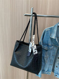Black braided handle tote bag with bow scarf hanging from strap