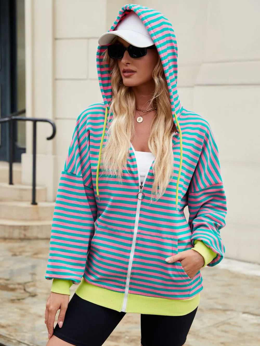 Striped zip-up hoodie with drawstring, teal and pink stripes, lime cuffs, front zipper