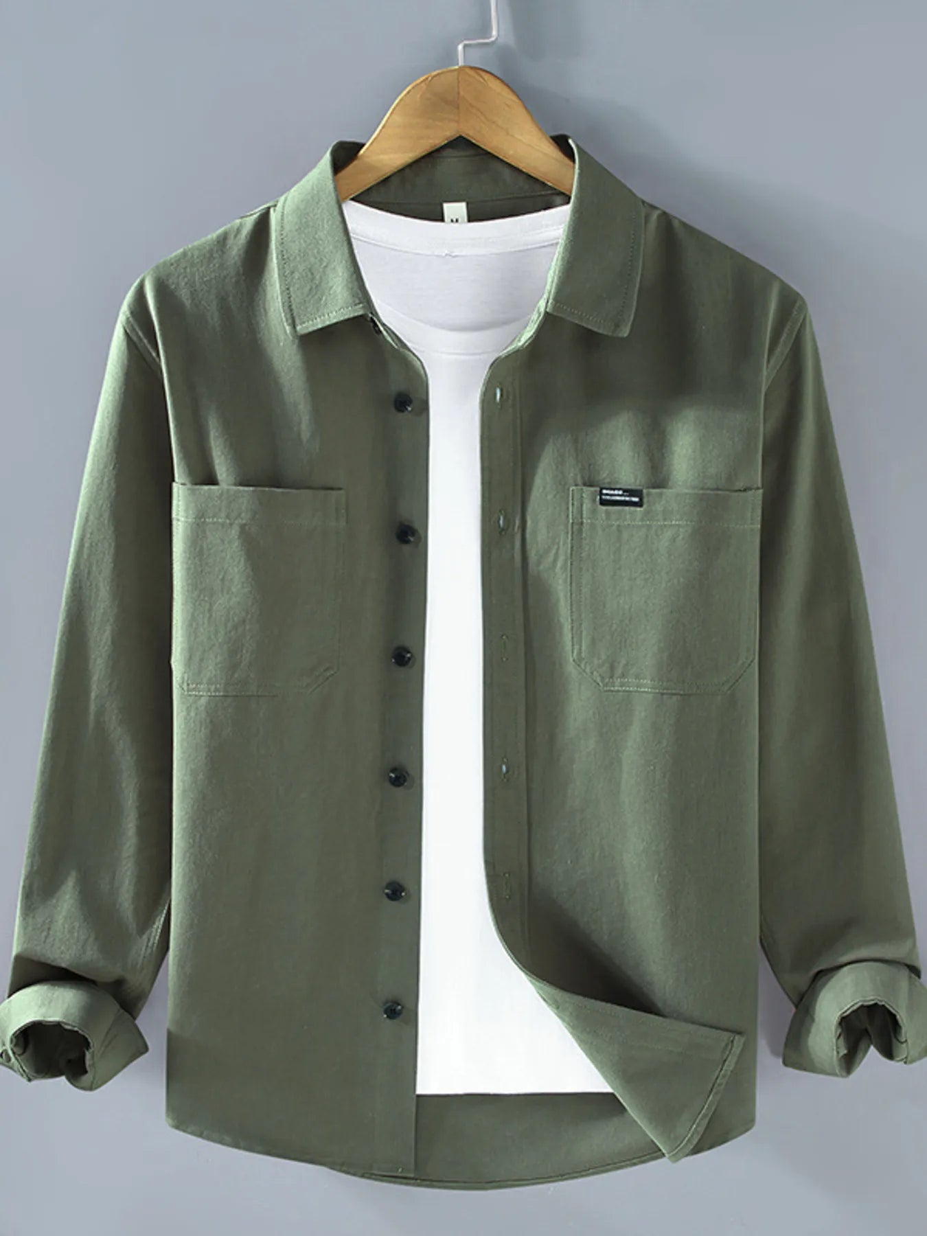 Dark green long sleeve button-up shirt with chest pockets and button front