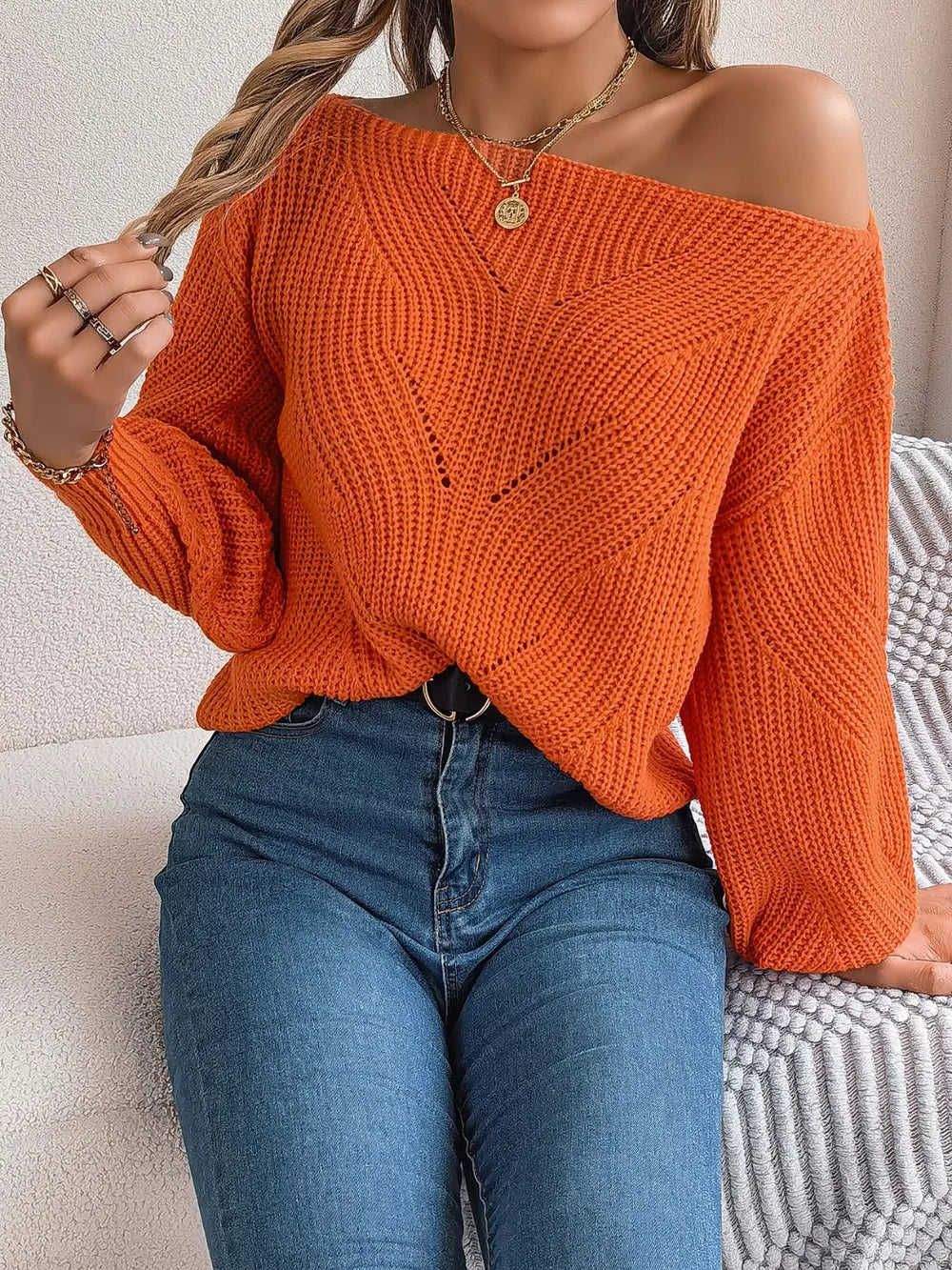 Openwork long-sleeve sweater in rust orange, off-shoulder knit with ribbed cuffs