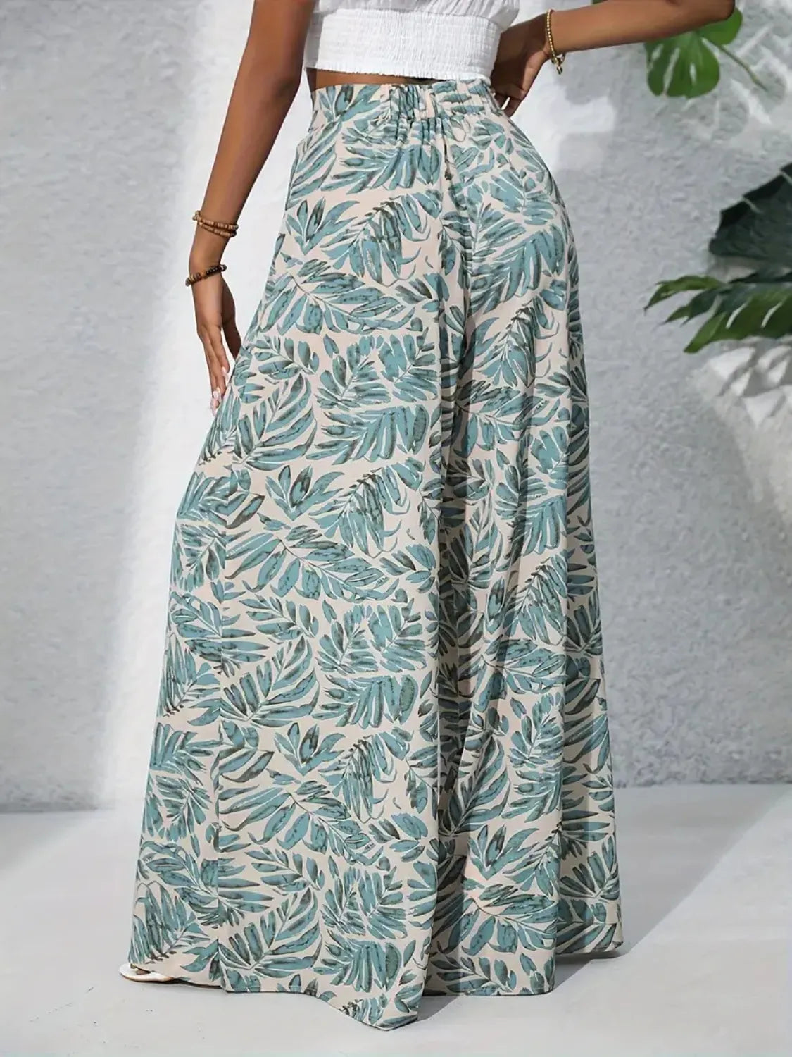 High-waist wide-leg pants with light teal leaf print and roomy wide legs