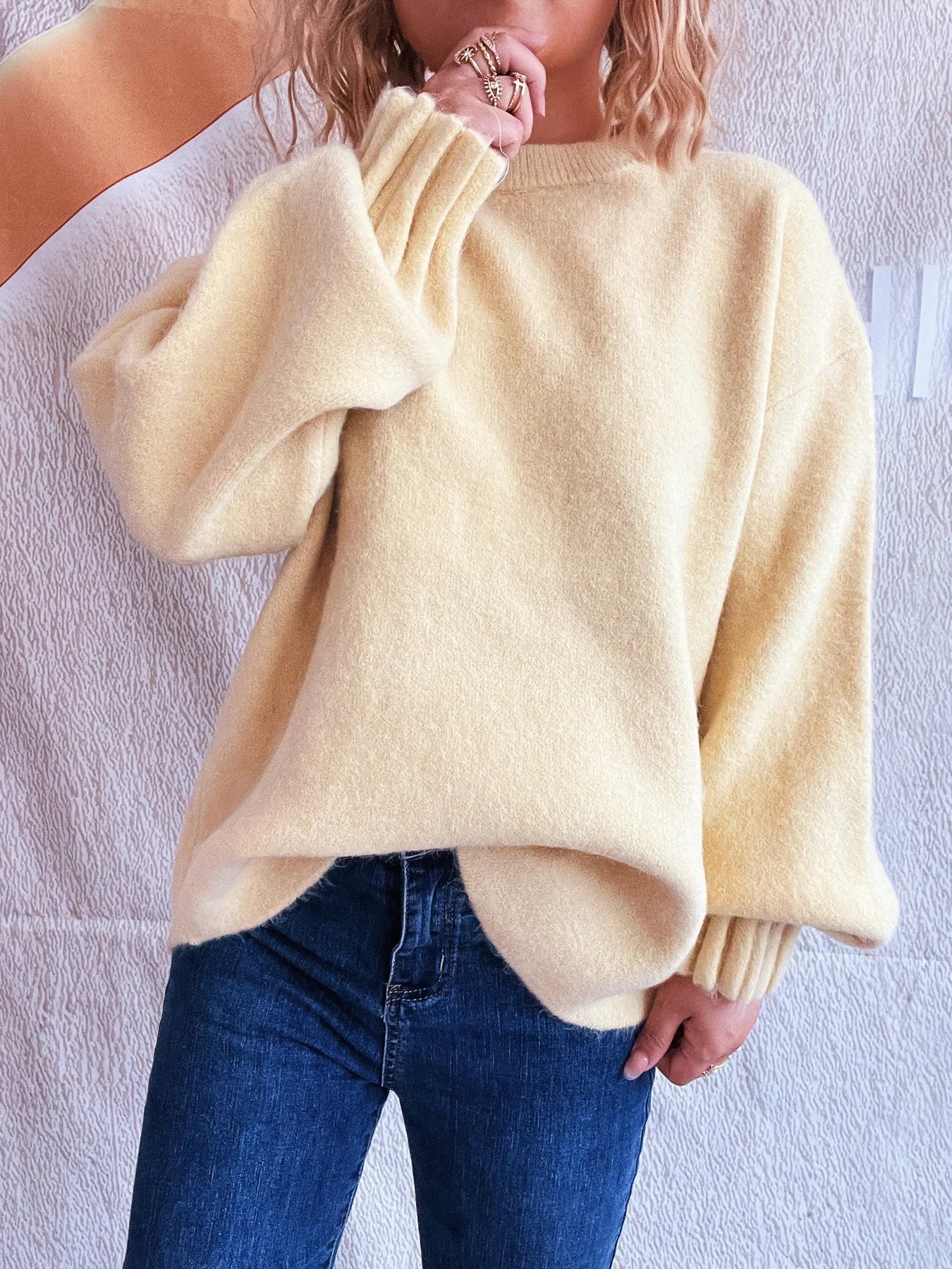 Cream round neck dropped-shoulder sweater with ribbed cuffs and cozy knit