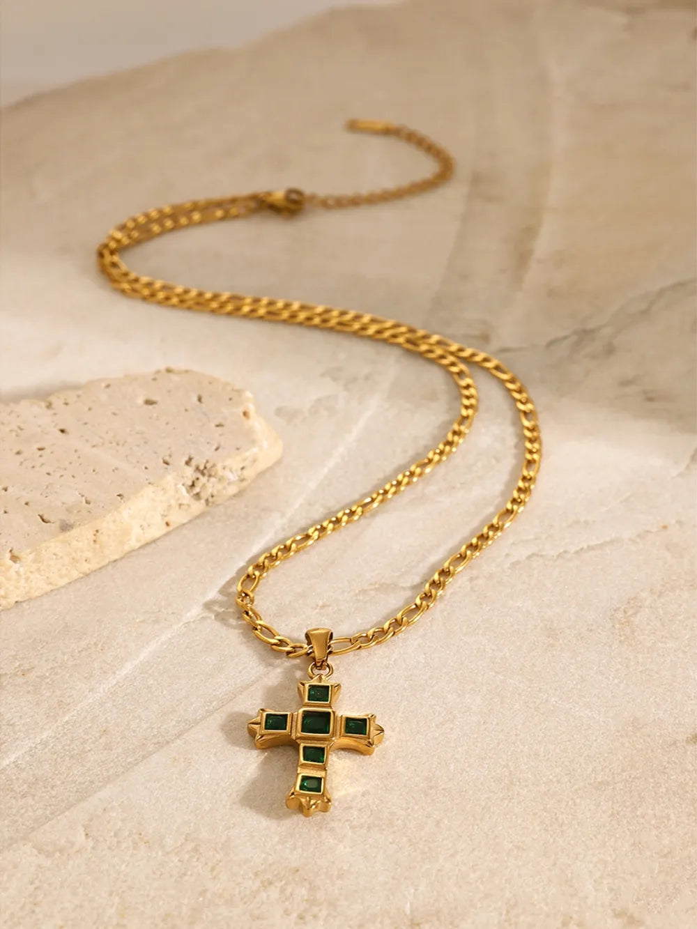 Gold-tone cross pendant necklace with green square-stone pendant on a chain