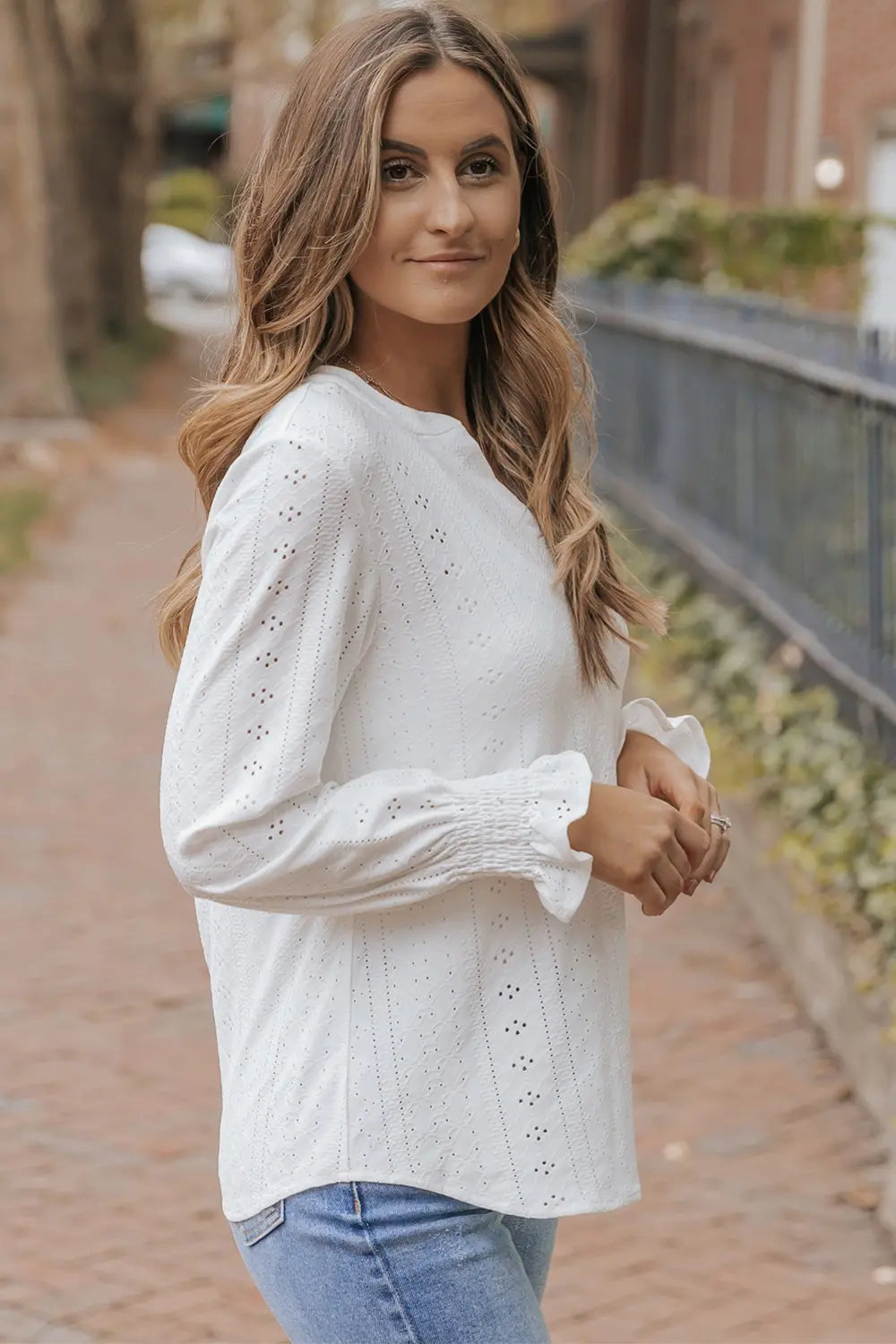 White openwork notched blouse with flounce sleeves, side front view