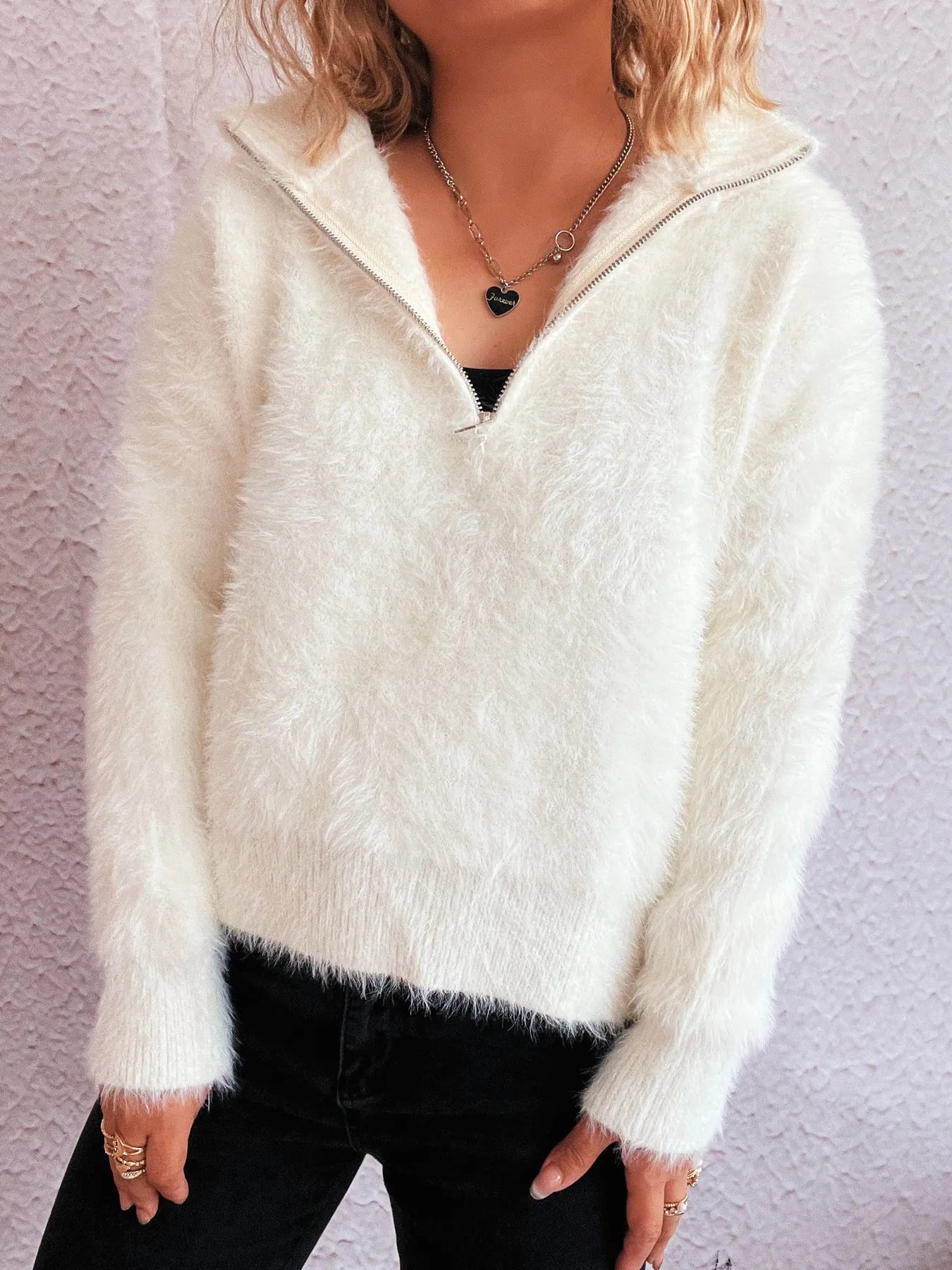 White fuzzy half-zip sweater with V-neck collar and long sleeves