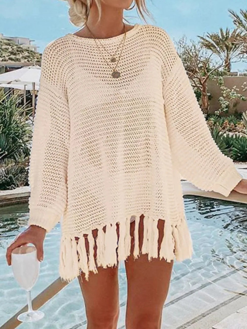 Cream openwork knit cover-up with long sleeves and red-brown tassel hem