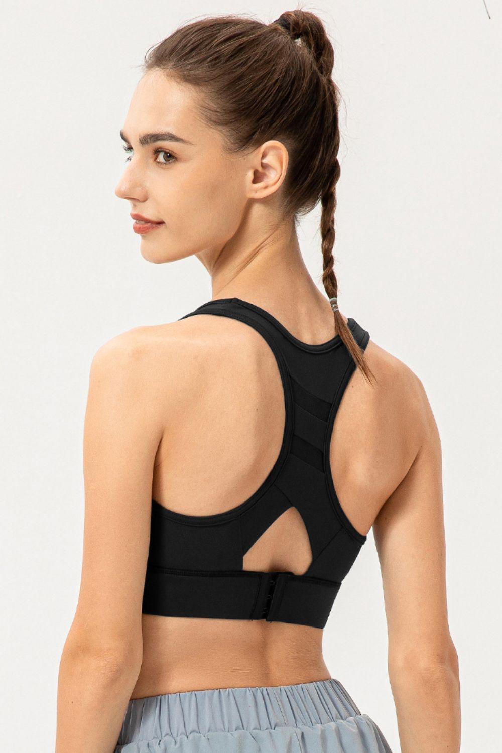Black longline sports bra back view with racerback straps and cutout panel
