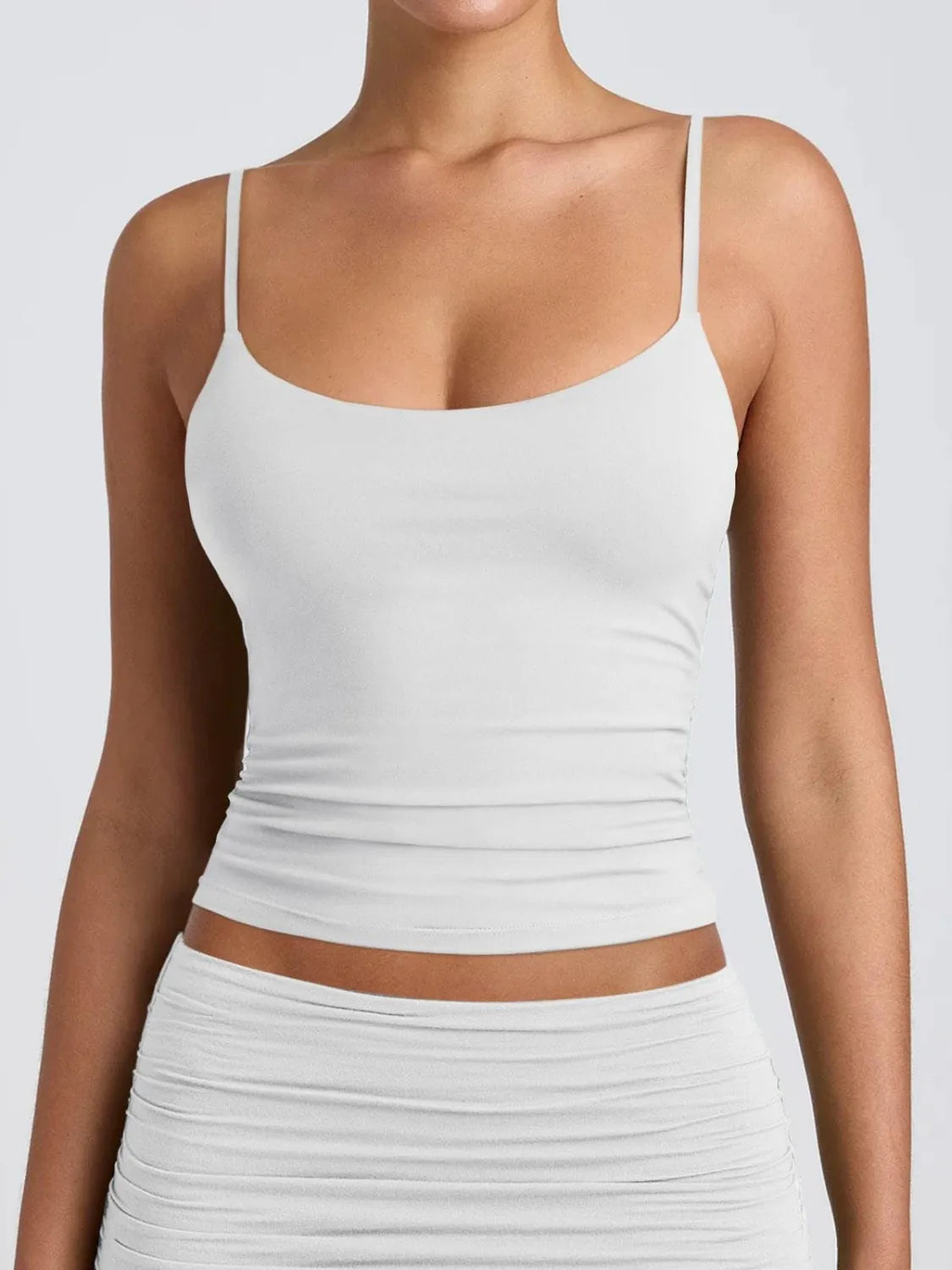White scoop-neck cami with thin straps and ruched stretch fit