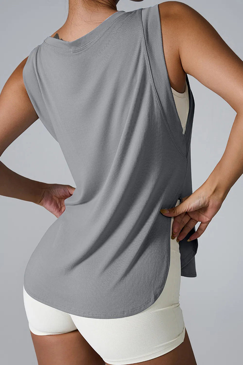 Gray sleeveless active tank top with round neck and side slit at the hem