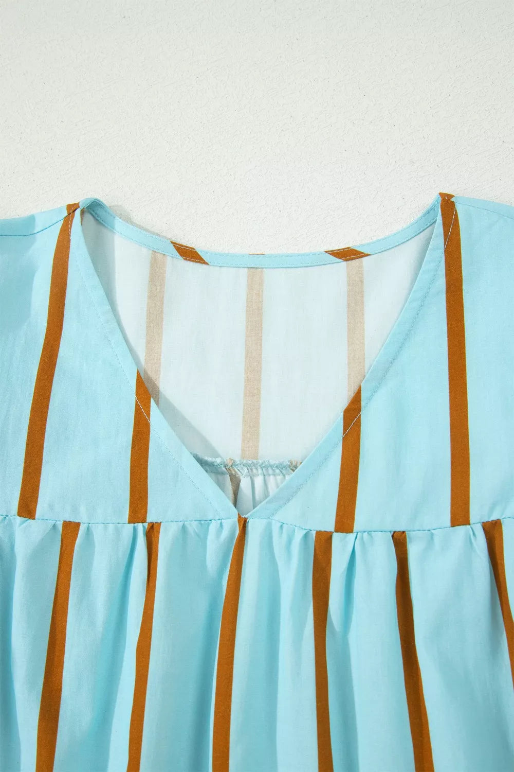 Cedar & Moore blue striped V-neck blouse with orange vertical stripes and gathered neckline